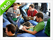Guys in the office with laptops